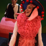 Al Kroeten and Miriam Gutierrez in Go Dog Go, dressed in dog costumes inside tiny cartoon cars