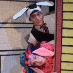 Al Kroeten and Miriam Guterriez in Go Dog Go, dressed as dogs and peeking around a door